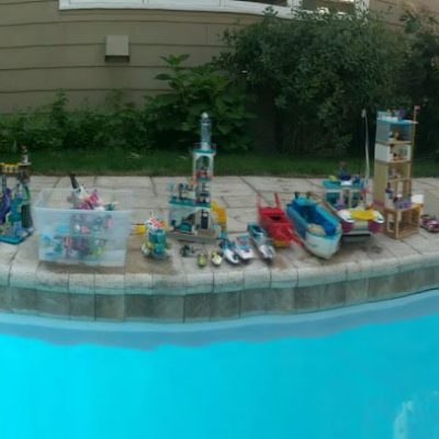 Panoramic of Lego toys at the edge of a pool